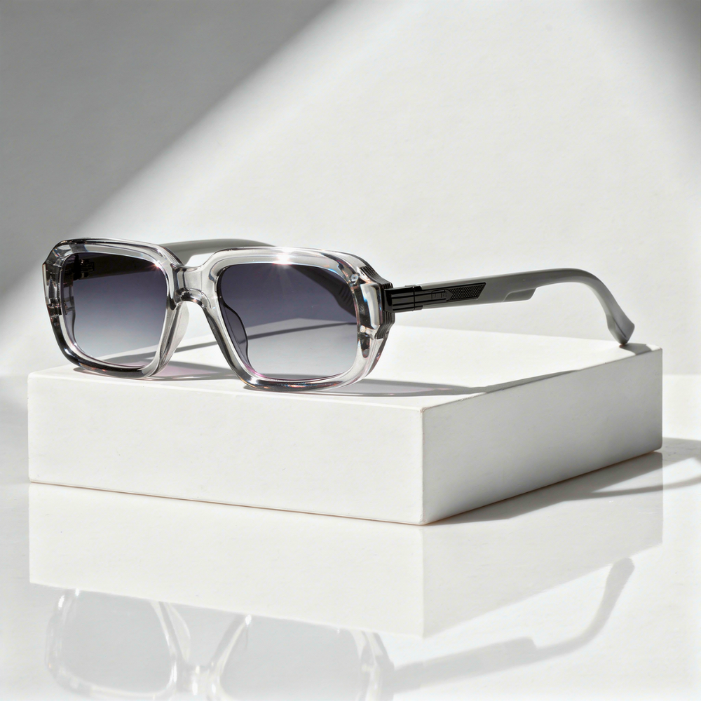 Sunglasses with gradient lenses on a white box against a light background