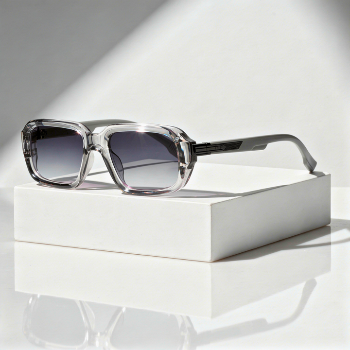 Sunglasses with gradient lenses on a white box against a light background